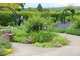 Ogród ziołowy w Wisley RHS Garden w Surrey w Anglii, został zaprojektowany przez Lucy Huntingdon i otwarty w lipcu 2003 roku